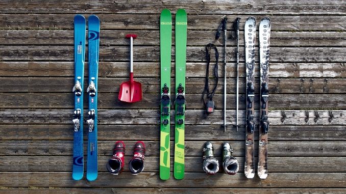 ski equipment -- skis, boots, and deep snow gear against rustic wood panel background