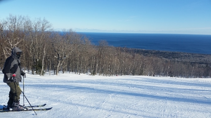 Stay warm skiing -- A skier overlooking Lake Superior at Lutsen Minnesota