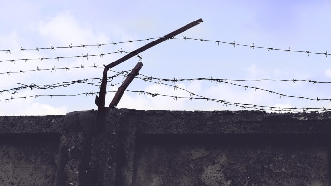 Epic, Ikon, Peak, etc The Debate on Multi-Resort Passes -- a prison wall with barbed wire