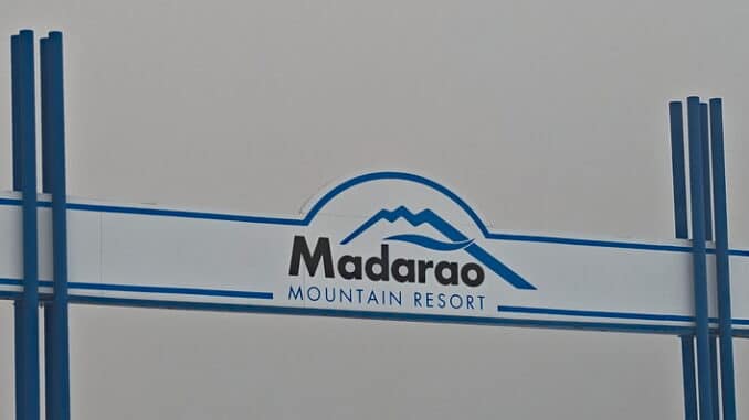 Madarao Ski Resort Japan -- Main sign against a cloudy sky