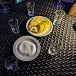 lemon slices, salt, and shot glasses